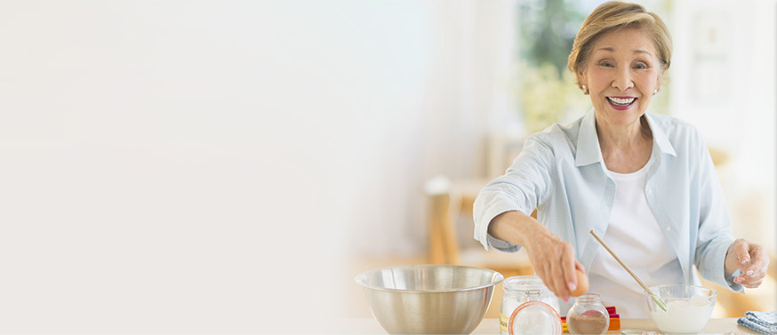 older woman baking in kitchen